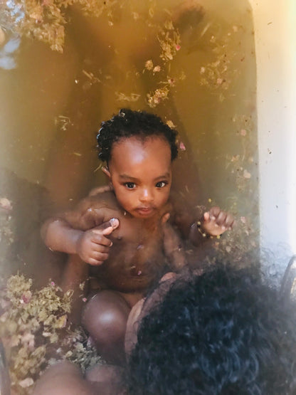 mum holding baby in bath